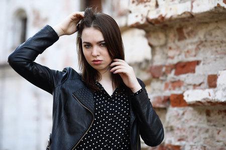 Girl on a walk through the spring city on a sunny dayの写真素材
