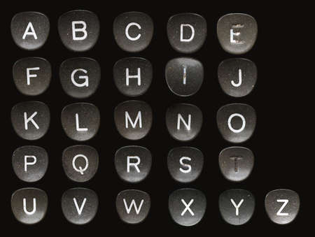 Full English alphabet on a key on a retro typewriter with a black backgroundの写真素材