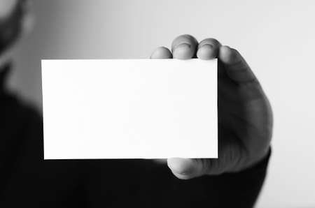 a small white piece of paper in his hand manの写真素材