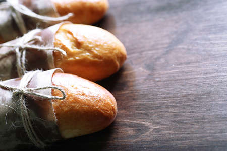 Freshly baked French baguette on a wooden table for breakfastの写真素材