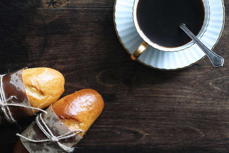 Freshly baked French baguette on a wooden table for breakfastの写真素材