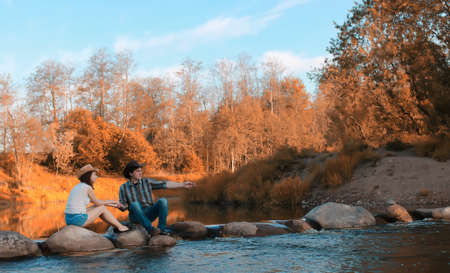 man and a girl are walking in the autumnの写真素材