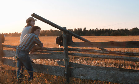 man and a girl are walking in the autumn