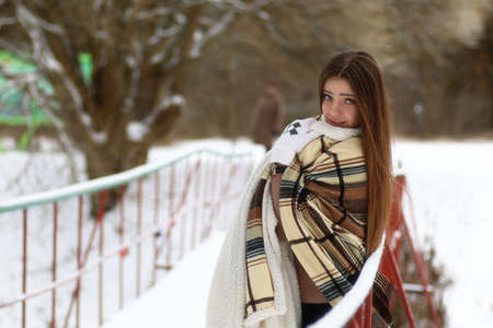 Young beautiful girl in winter snowy dayの写真素材