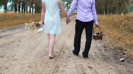 Just married lovers walking in a field in autumn dayの写真素材
