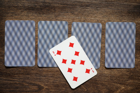 Playing chips on a wooden texture table and a deck of cards