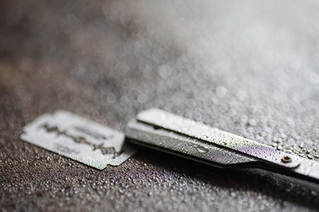Shaving accessories on a wooden texture background and disposable blades