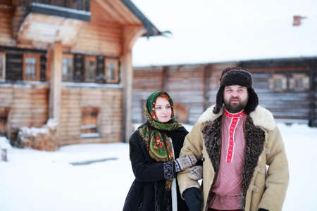 Couple in traditional winter costume of peasant in russiaの写真素材