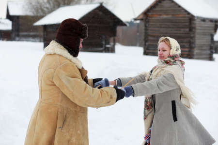 Couple in traditional winter costume of peasant in russiaの写真素材