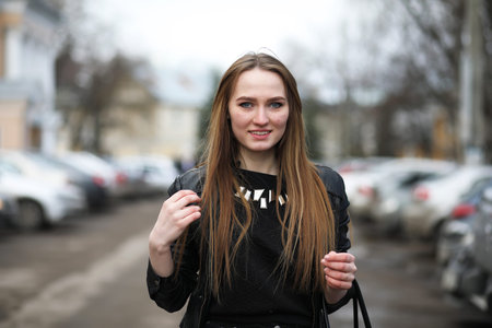 Young cute girl on a walk in the cityの写真素材