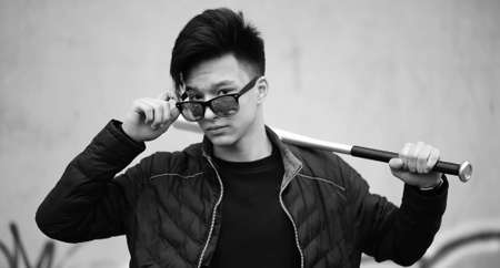 Black White photo of Asian young man outdoors posingの写真素材