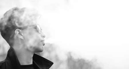 Black White photo of Asian young man outdoors posingの写真素材