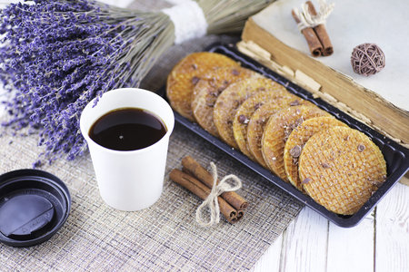 Viennese wafers with caramel on a wooden white background