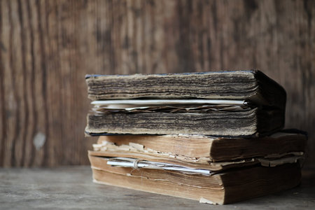 Old books on a wooden table and glass magnifier