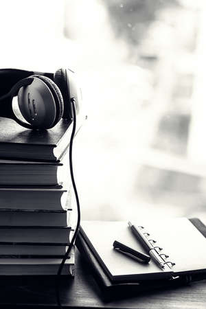 A stack of textbooks on the windowsill and writing utensilsの写真素材