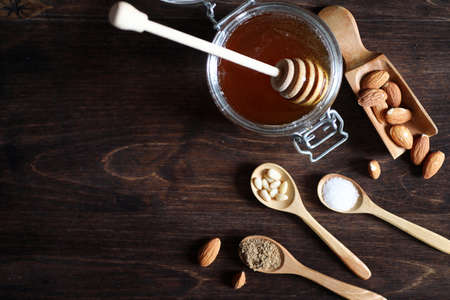 Fresh nuts on the table for breakfast with honey and cakeの写真素材