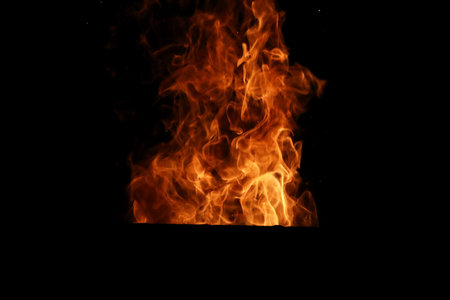 Tongues of flame of fire of orange-yellow color from burning fir