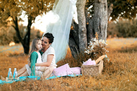 Mother with her daughter at a picnicの写真素材