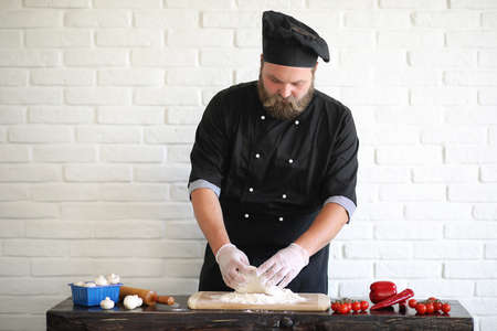 Bearded chef chef prepares mealsの写真素材
