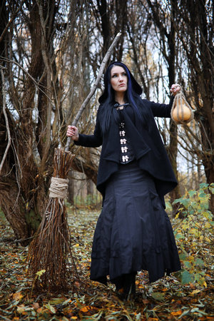 A woman in a witch suit in a forestの写真素材