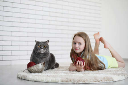 little girl lies on the floorの写真素材