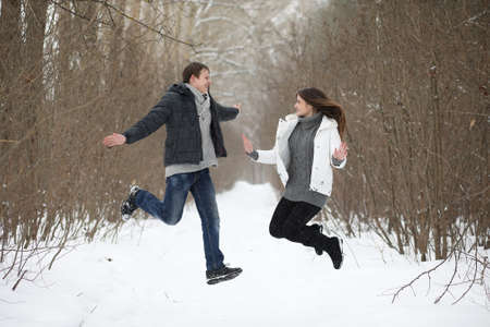 pair of lovers on a date winter afternoon in a snow blizzardの写真素材