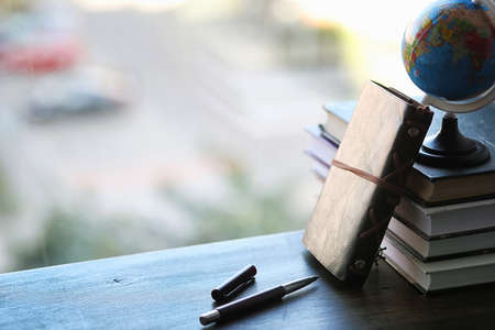 A stack of textbooks on the windowsillの写真素材