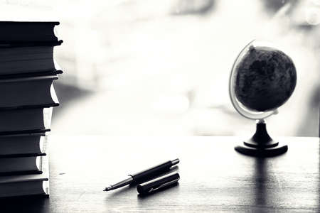 A stack of textbooks on a tableの写真素材