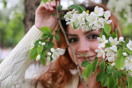woman with branch apple flowerの写真素材