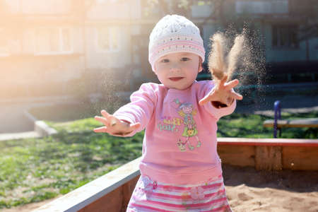 small child playing in the backyard and in the sandboxの写真素材