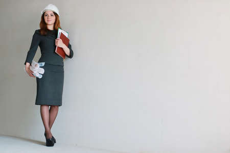 female architect at the construction site with drawings and noteの写真素材