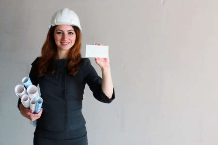 woman with a blank sheet of paper in his hand on construction siの写真素材