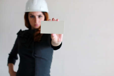 woman with a blank sheet of paper in his hand on construction siの写真素材