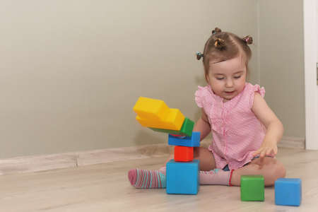 Young kid playing on a floor in a roomの写真素材