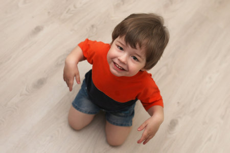 Young kid playing on a floor in a roomの写真素材