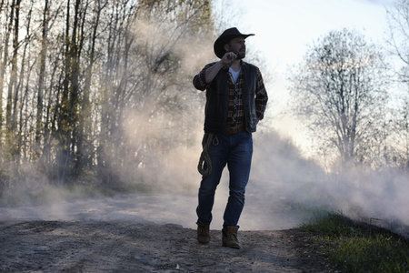 A cowboy in a thick smoke on the road