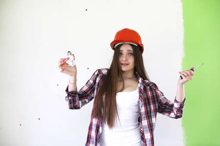 A girl doing repairs in the apartmentの写真素材