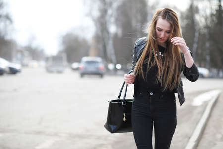 A young cute girl walking alone in the cityの写真素材