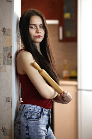 Pretty girl posing at camera in apartmentの写真素材