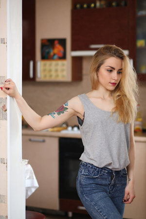 A pretty girl posing for the camera in an apartmentの写真素材