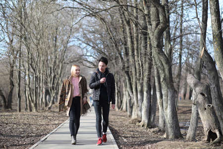 A couple of friends walking together in the parkの写真素材