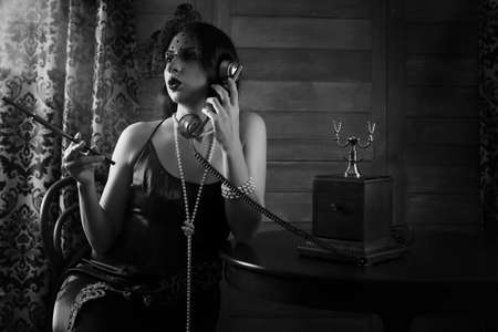 Beautiful 1930s girl smokes monochromeの写真素材