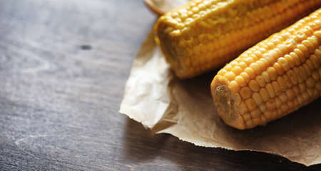 Fresh corn. Natural food from corn cob with salt. Rural Mexican food. Healthy food. Boiled and fried corn cobs on wooden table are served with salt.の写真素材