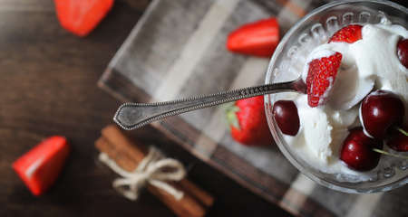 Fresh yogurt berries. Ice cream in a bowl with fresh and juicy strawberries and cherries. Dessert with red berries.の写真素材