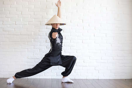 Asian young novice on a white brick wallの写真素材