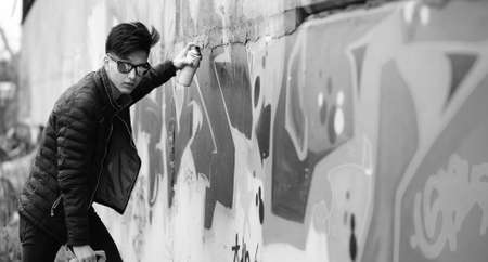 Black White photo of Asian young man outdoors posingの写真素材