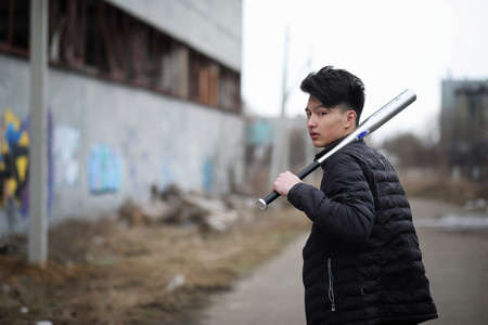 Asian young man on the street posing at the cameraの写真素材