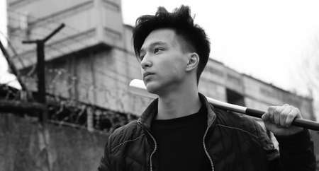Black White photo of Asian young man outdoors posingの写真素材