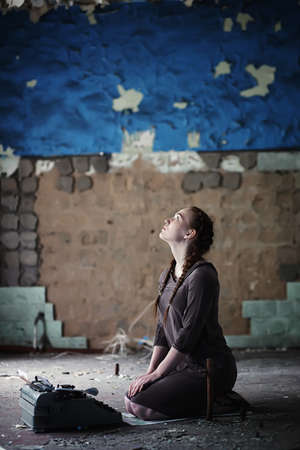 A girl with old books in the old houseの写真素材