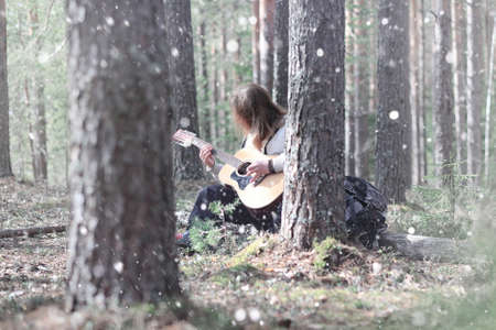 Guitarist in the woods at a picnic. A musician with an acousticの写真素材